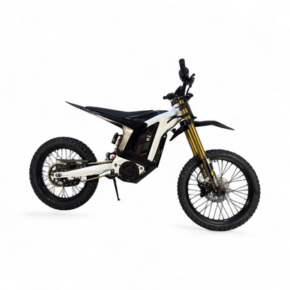 Right-side view of a sleek white and black electric dirt bike with gold forks and a red rear spring.